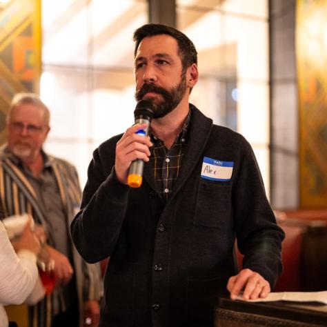 Man speaking into microphone. 