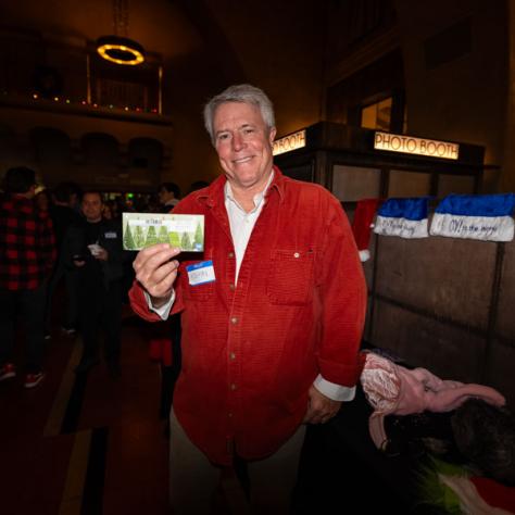 Person posing for photo smiling with certificate. 