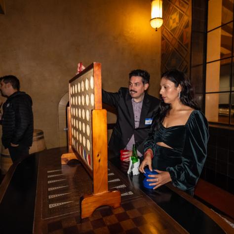 People playing giant connect four. 