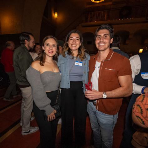 People posing for photo at party.