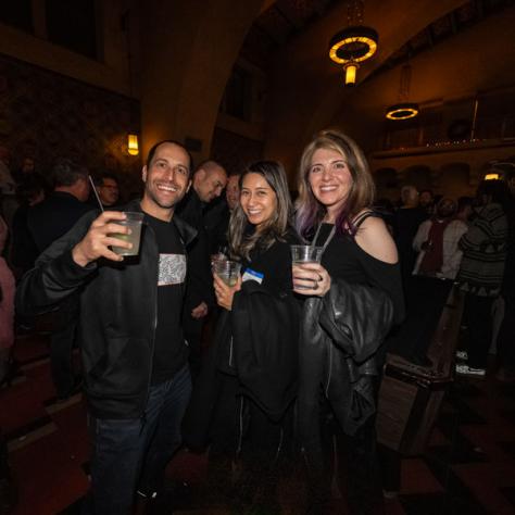 People posing for photo at party.