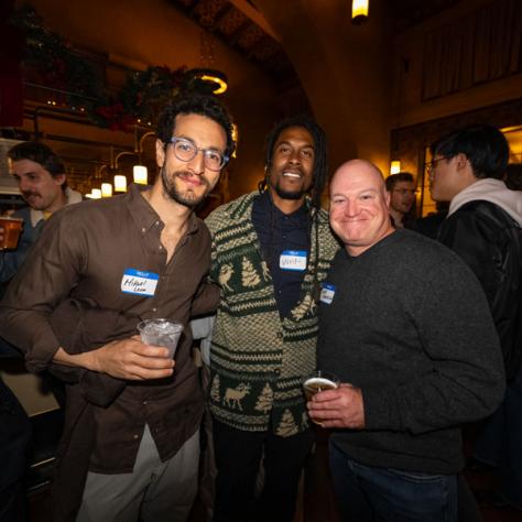 People posing for photo at party.