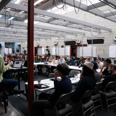 View of room with people sitting at a table. 