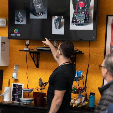 Man pointing at tv screen. 