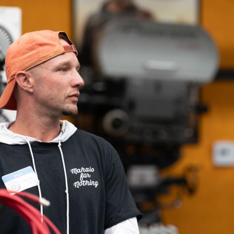 Man with orange hat and cable candid photo. 