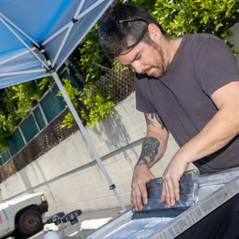 Man working under tent. 