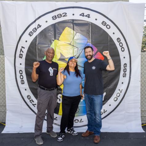 People posing for photo with fists up. 