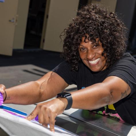 Woman smiling making a sign. 