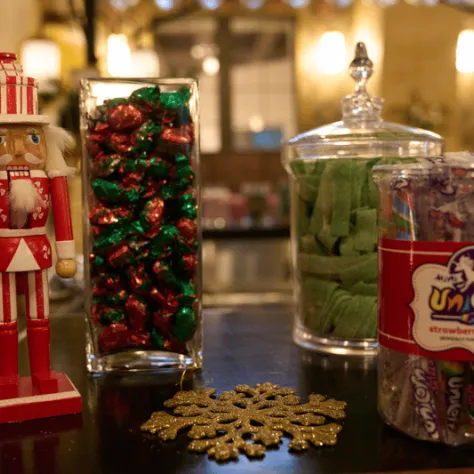 Nutcracker and candy jars on a table. 