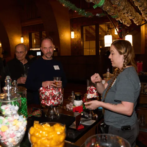 People talking at the candy bar. 