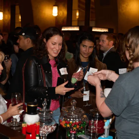 People getting drinks and candy at the bar. 