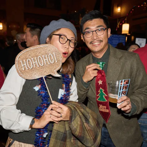 People posing for photo together with signs. 