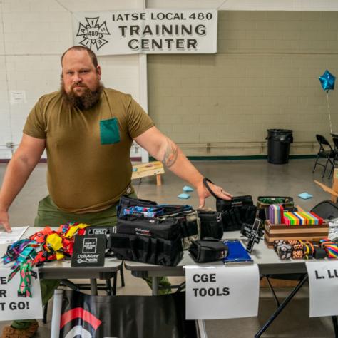 Man at yard sale table. 