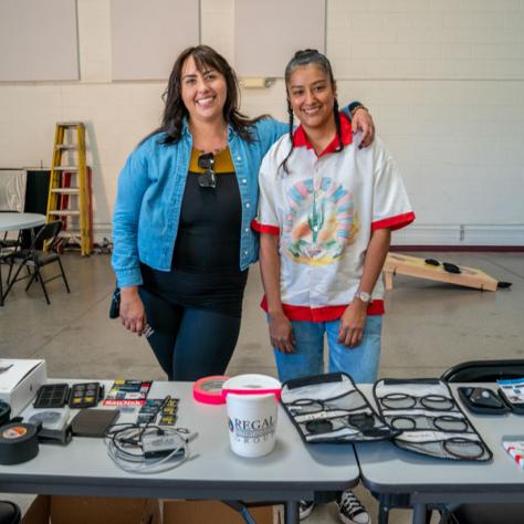 People posing for photo at yard sale.