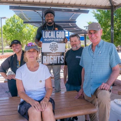 People at table posing for photo together. 