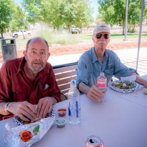 People posing for photo together at a table. 