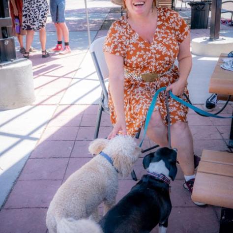 Woman posing with two dogs. 