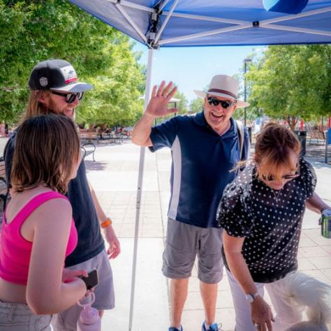 Candid photo of people under an umbrella. 