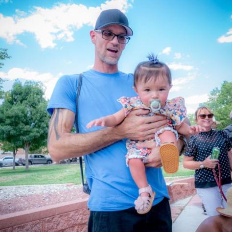 Man and baby posing for photo. 