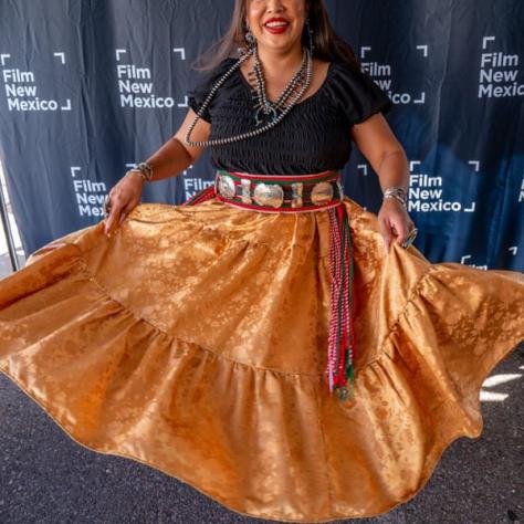 Woman in gold skirt. 