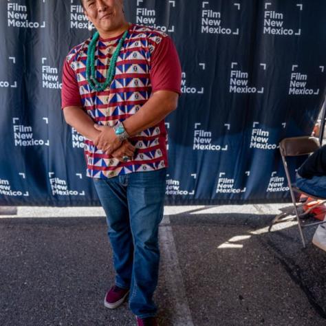 Man in red shirt posing for photo. 