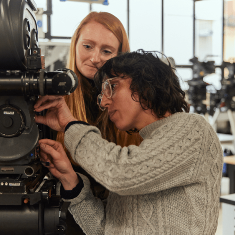 People working with a camera.