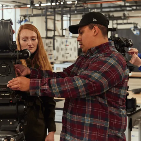 People working with a camera.