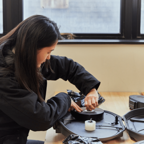 Woman at table working with film. 