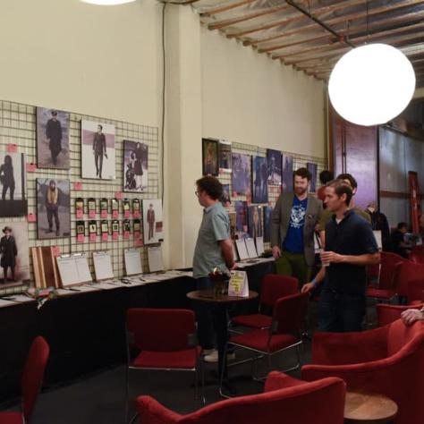 People looking at art on the wall. 