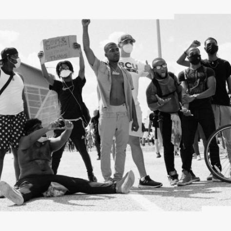 Photo of a group of people holding up signs. 