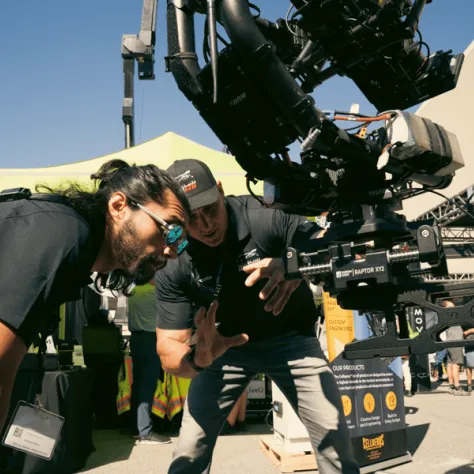 Men working behind a camera. 