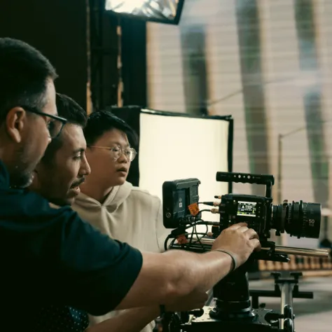 People working behind a camera. 