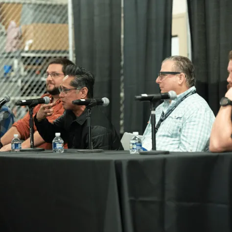 People sitting at a table with mics. 