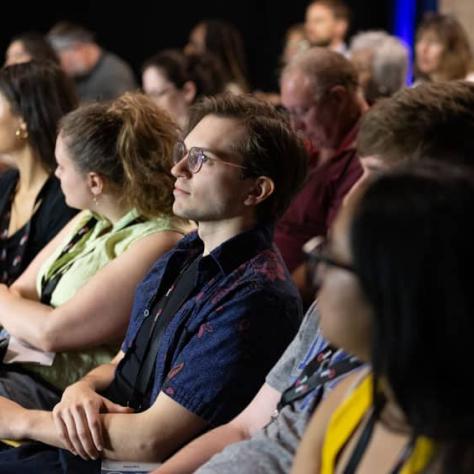 Audience watching something. 