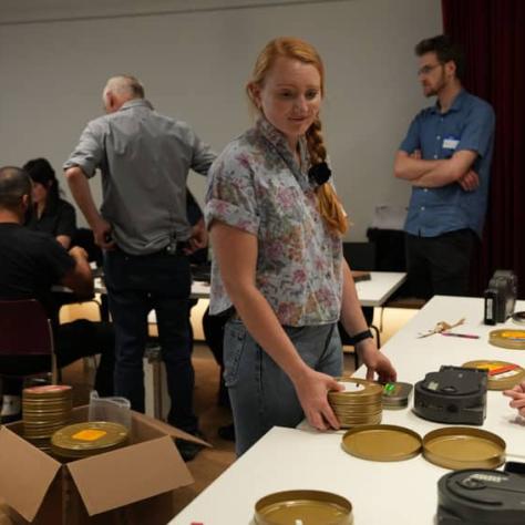 Woman looking at film on a table. 