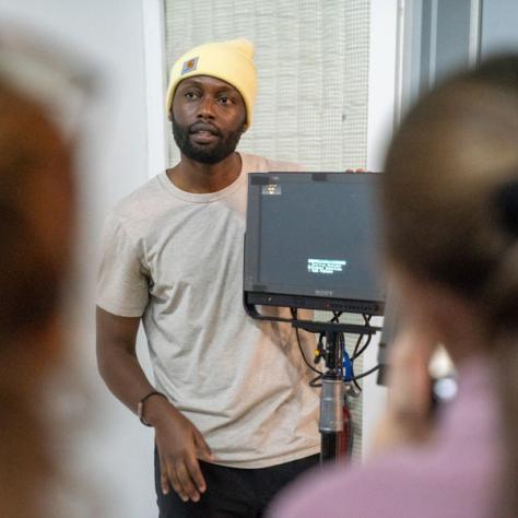 Man in a yellow hat standing.