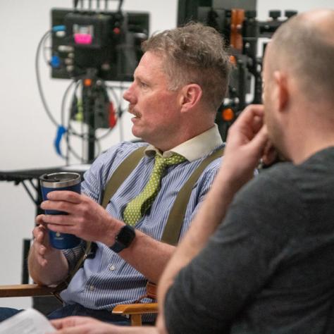 Two people sitting on a panel. 