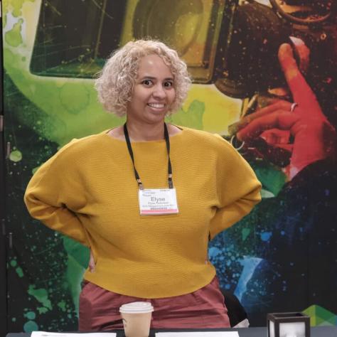 Woman standing at desk. 