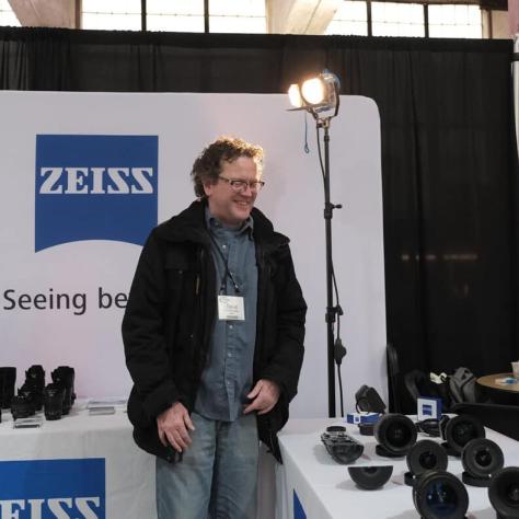 Man standing in front of table with equipment. 