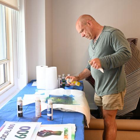 Man decorating t-shirt. 