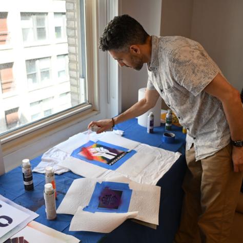 Person decorating t-shirt. 