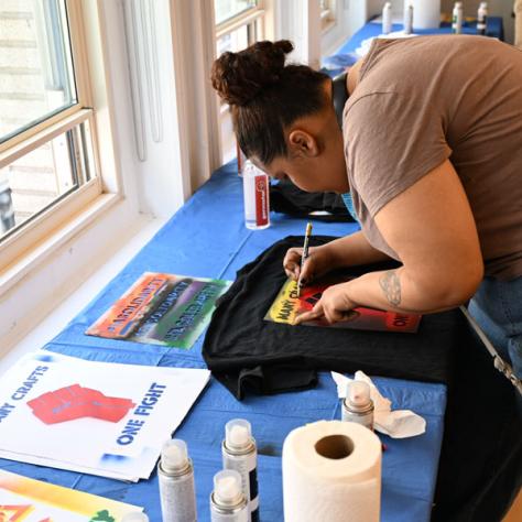 Person decorating t-shirt. 