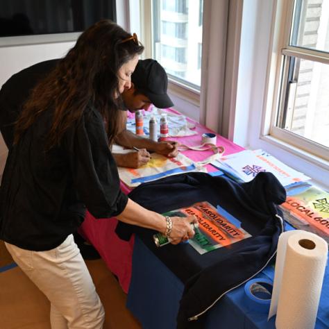 Person decorating t-shirt. 