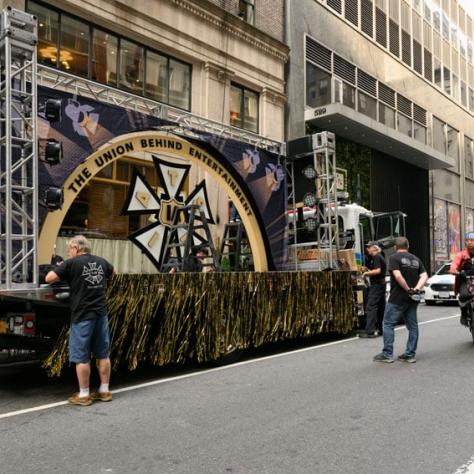 People and large float outside on the street. 