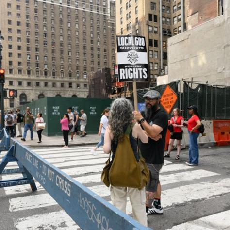 People outside on the street holding signs.