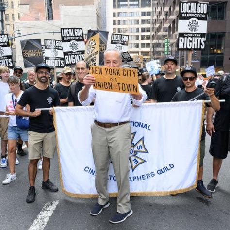 People marching with signs and banner. 