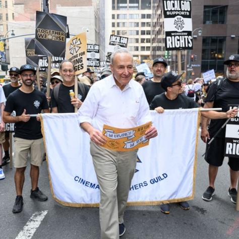 People marching with signs and banner. 