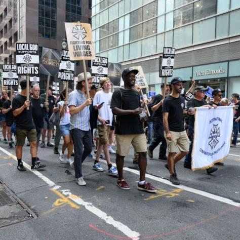 People marching with signs and banner. 