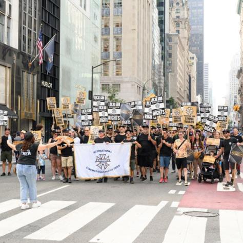 People marching with banner and signs. 