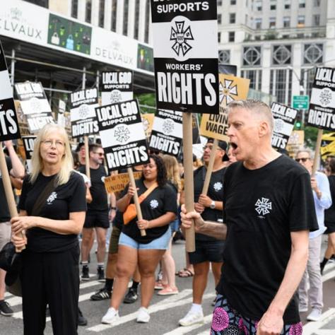 People marching and holding up signs. 